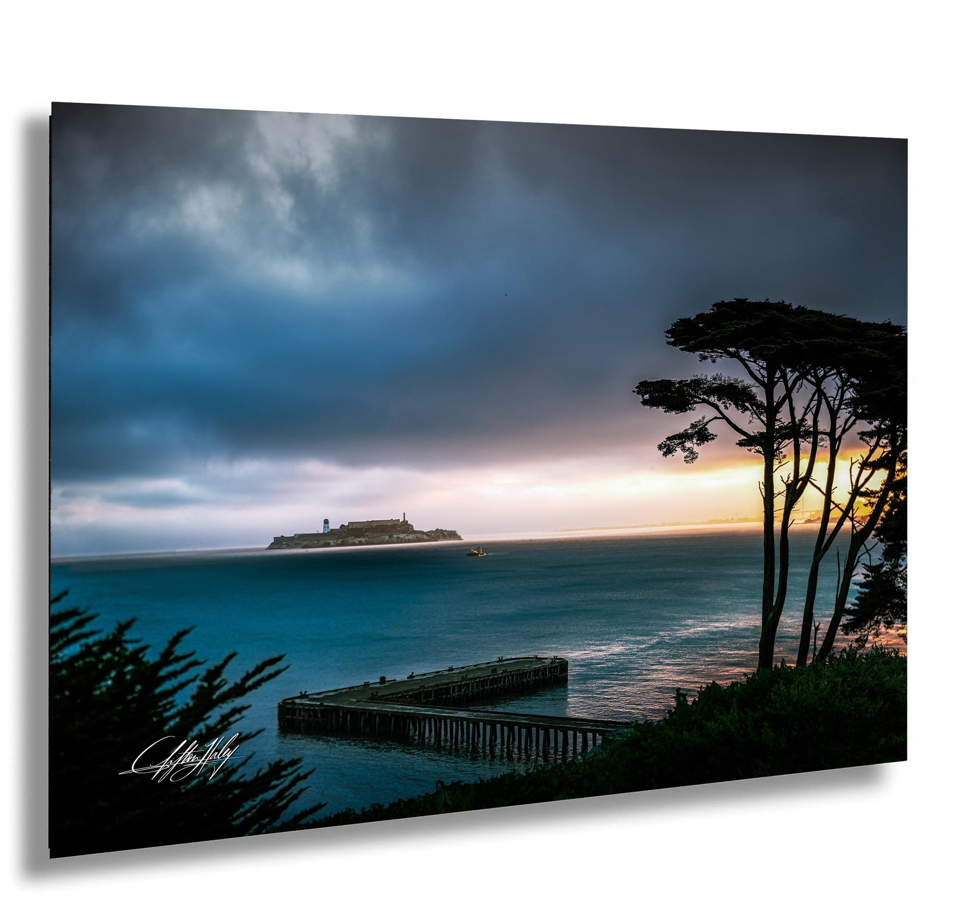 a serene coastal scene with a pier extending into the ocean, a small island in the distance, and a dramatic sky with clouds and a colorful sunset.