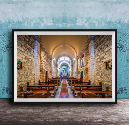 a serene and peaceful church interior, with rows of wooden pews lining the walls and a large arched window at the far end. The walls are made of stone, and the ceiling is adorned with arched windows, creating a warm and inviting atmosphere. The overall scene conveys a sense of tranquility and reverence, typical of a place of worship.