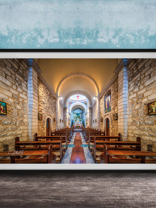 a serene and peaceful church interior, with rows of wooden pews lining the walls and a large arched window at the far end. The walls are made of stone, and the ceiling is adorned with arched windows, creating a warm and inviting atmosphere. The overall scene conveys a sense of tranquility and reverence, typical of a place of worship.