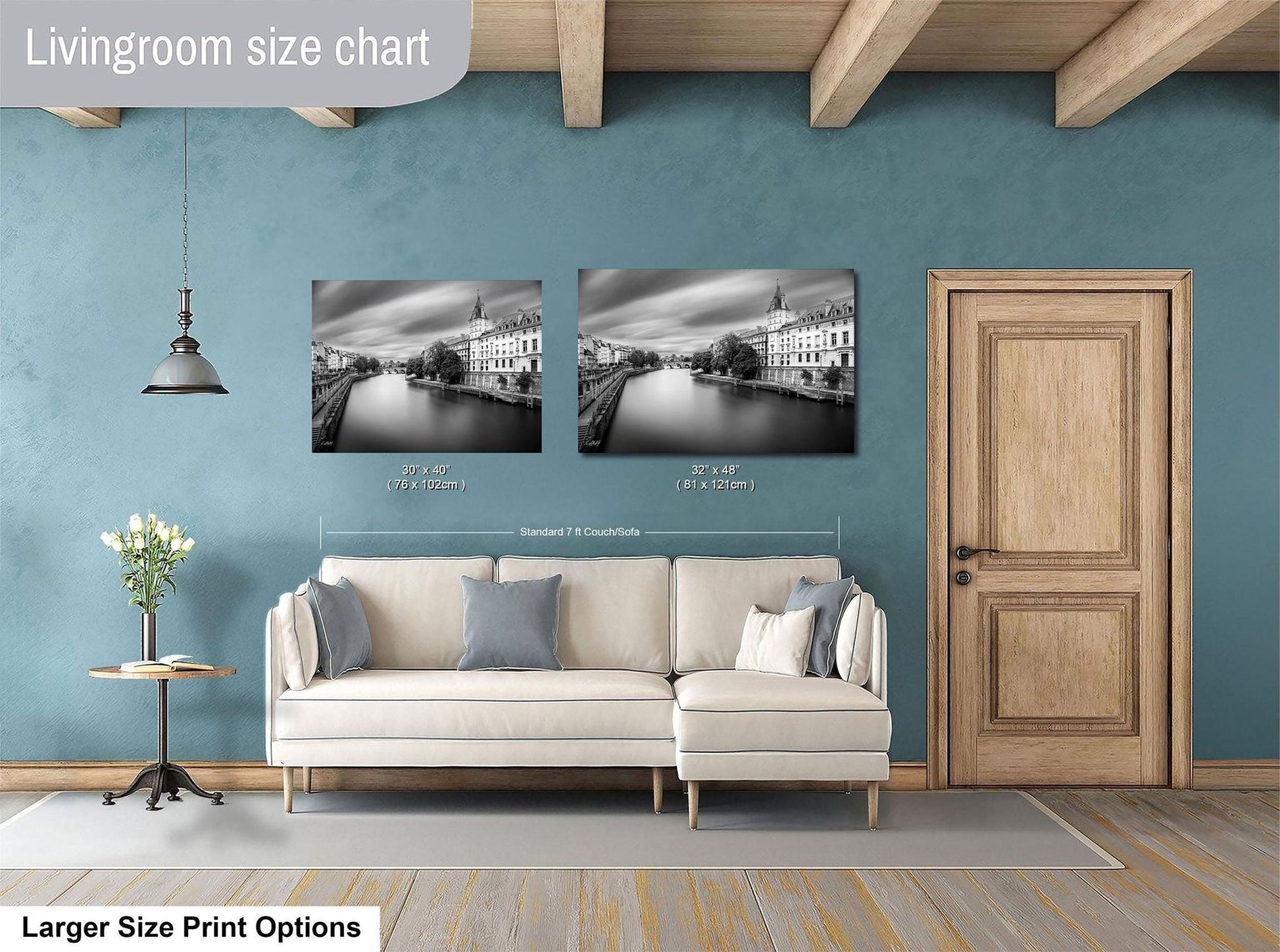 a living room with a white sofa, a wooden door, and a painting of a cityscape on the wall.