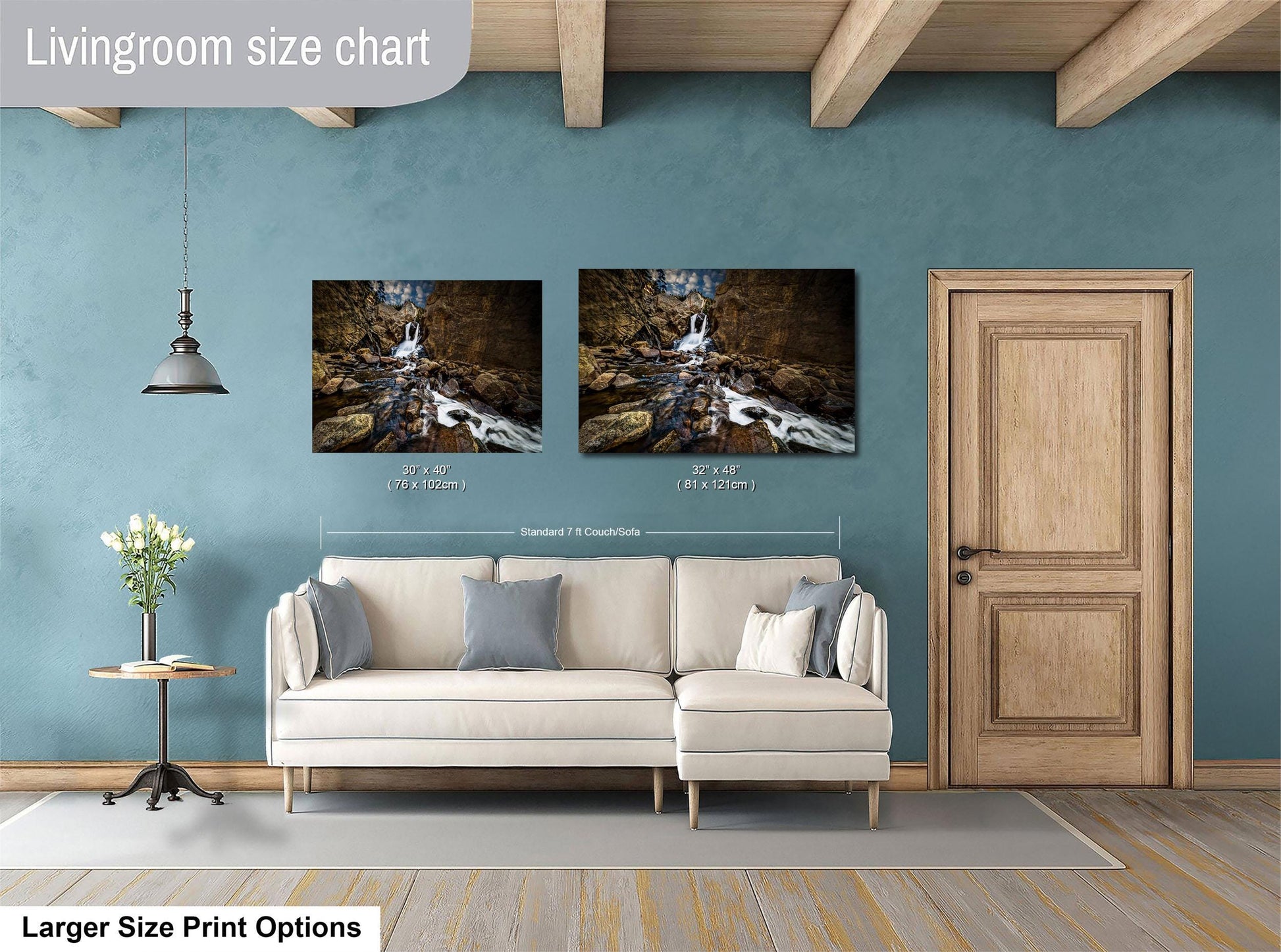 a living room with a white sofa, a wooden door, and two framed photographs hanging on the wall.