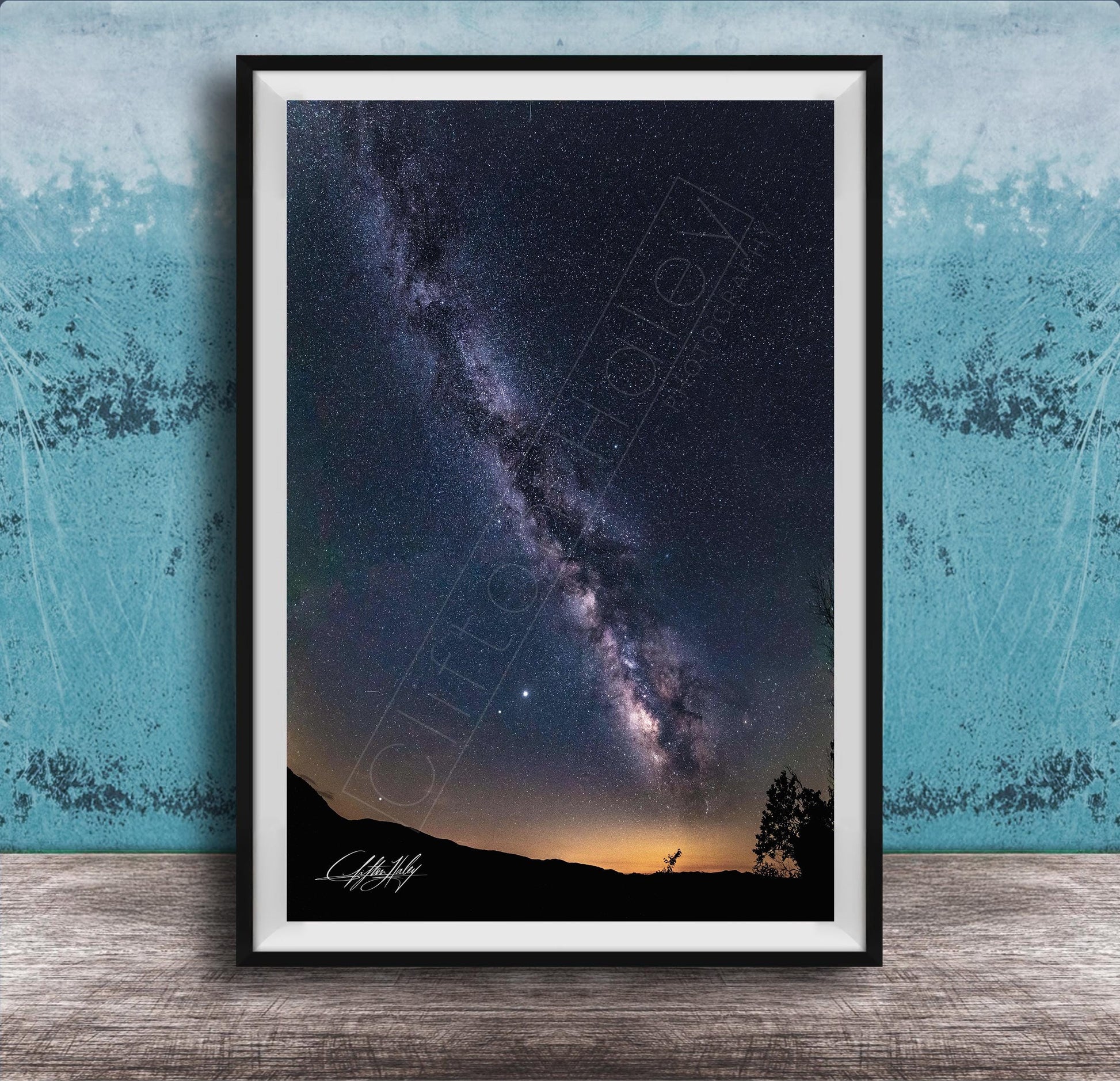The image is a framed photograph of a night sky with the Milky Way galaxy, a stunning celestial display.