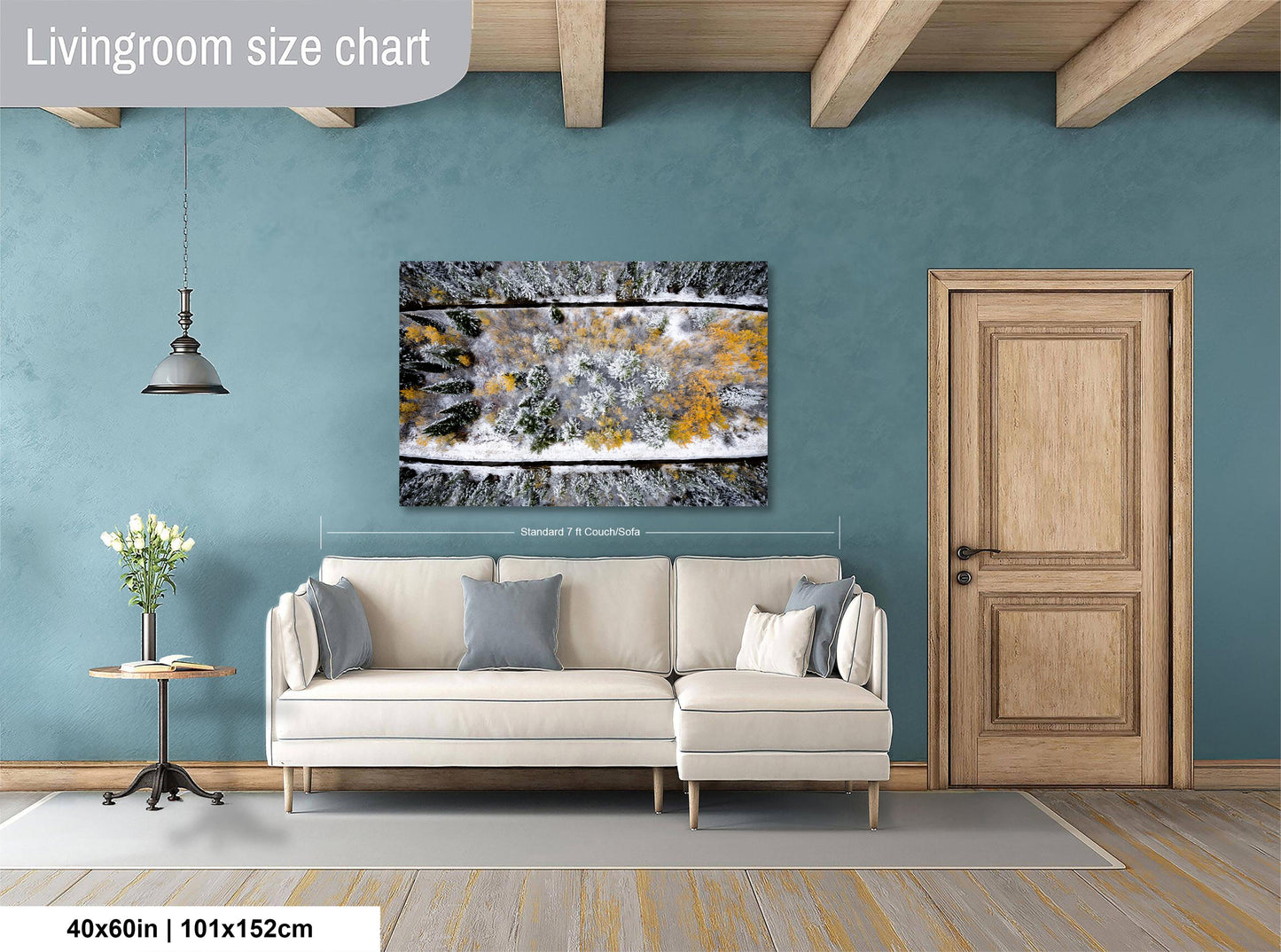 a living room with a large painting of a snowy landscape hanging on the wall. The painting is framed and appears to be the focal point of the room. The living room has a white sofa and a wooden door, creating a cozy and inviting atmosphere.