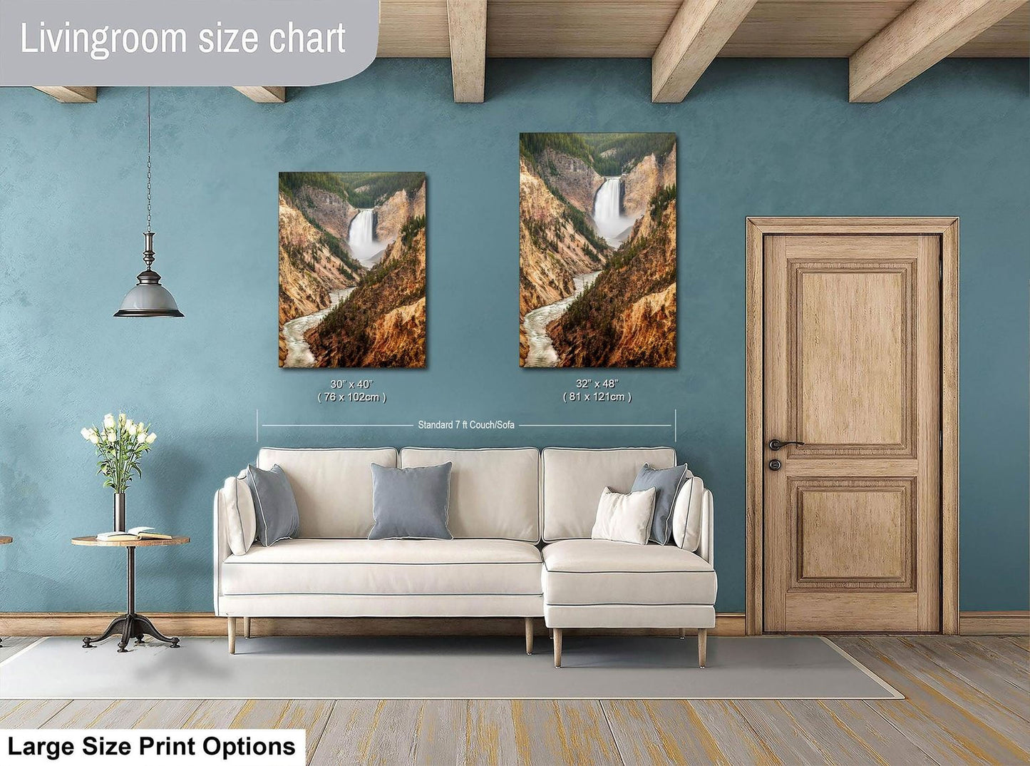 a living room with a white sofa, a wooden door, and two framed landscape photographs hanging on the wall.