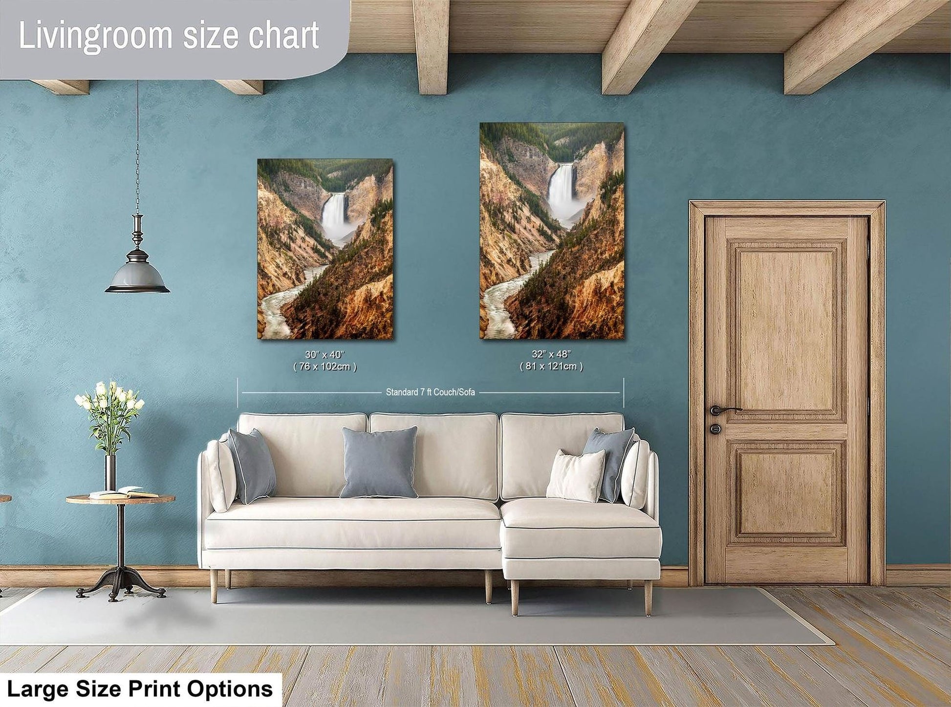 a living room with a white sofa, a wooden door, and two framed landscape photographs hanging on the wall.