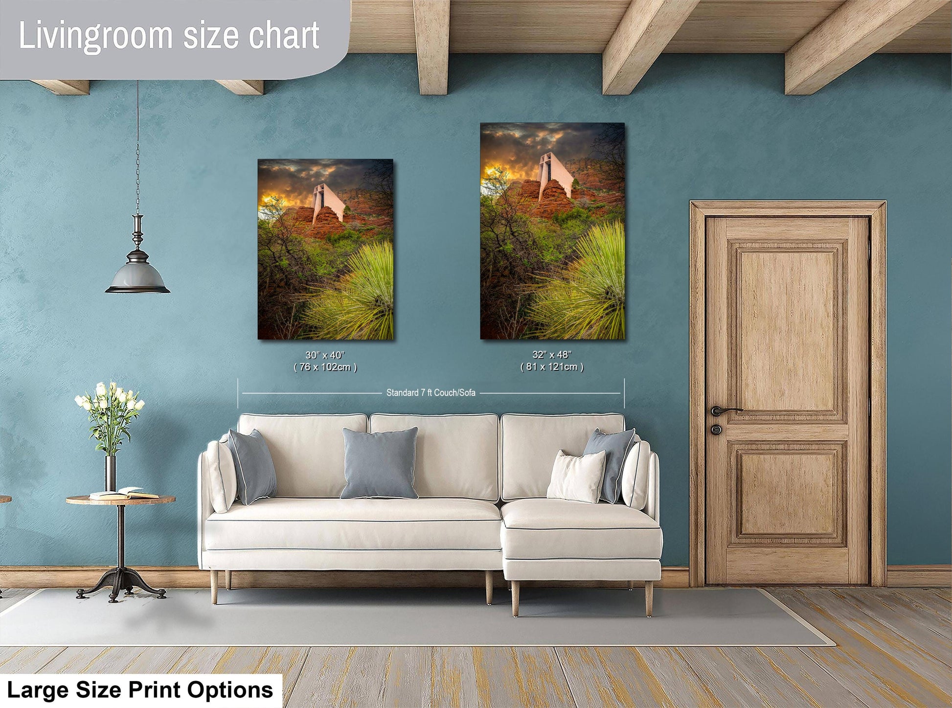 a living room with a white sofa, a wooden door, and two framed landscape paintings hanging on the wall.