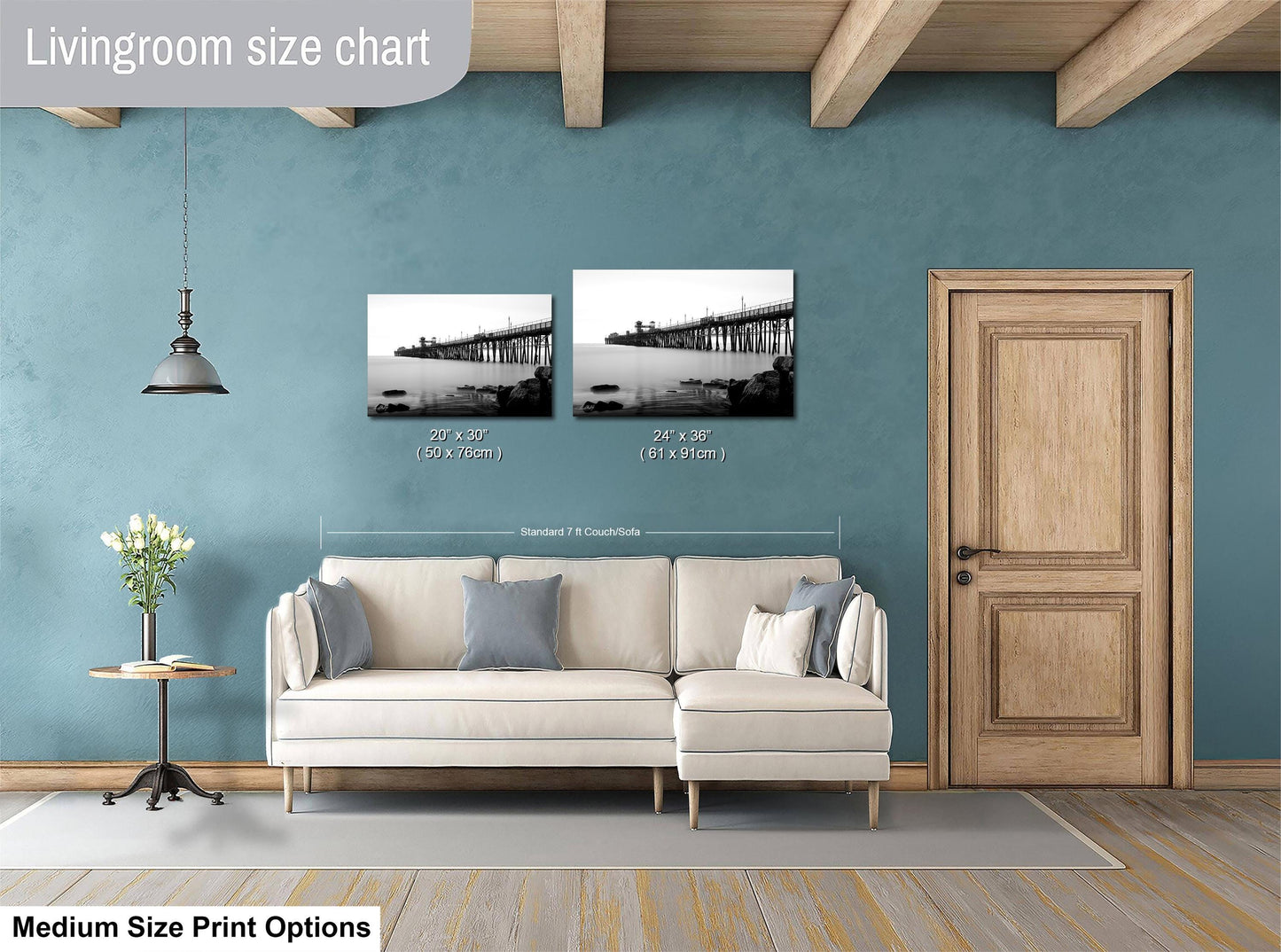 a living room with a white sofa, a wooden door, and a painting of a bridge on the wall. The painting is of a standard size of 24x36 inches.