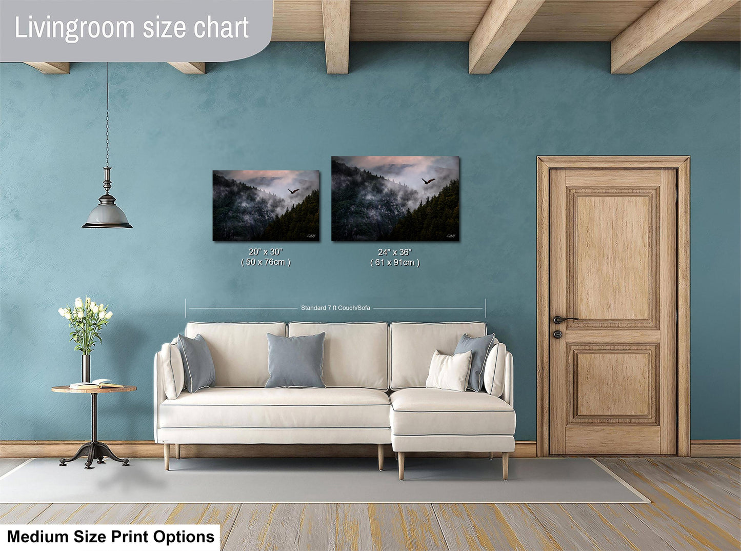a living room with a white sofa, a wooden door, and a painting of a mountain landscape on the wall.