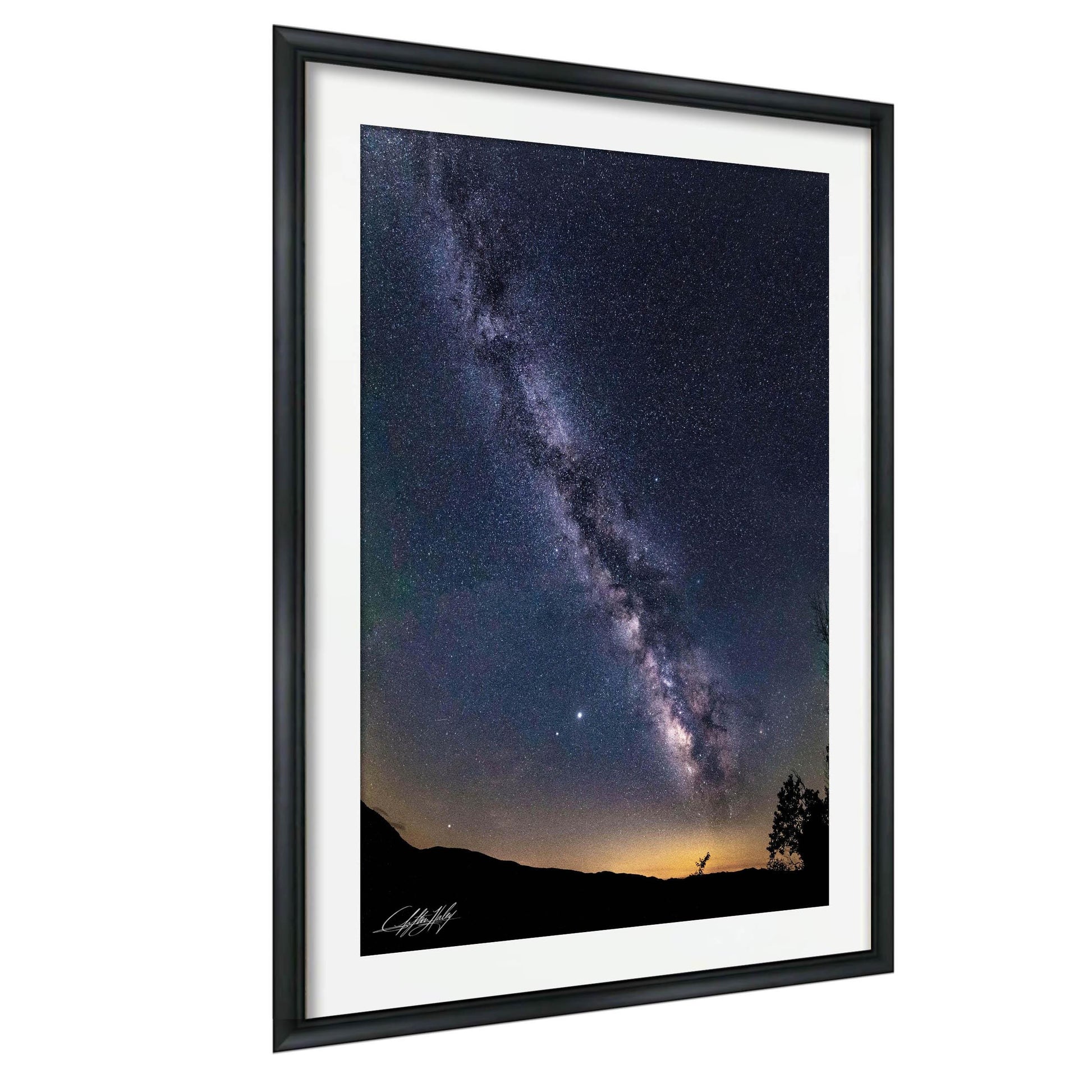 a stunning night sky with the Milky Way galaxy stretching across the frame, its bright white stars contrasting against the dark blue backdrop.