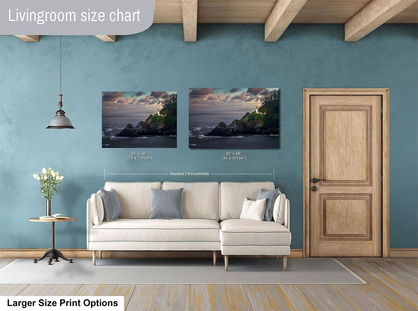 a living room with a white sofa, a wooden door, and a painting of a coastal landscape above the sofa.