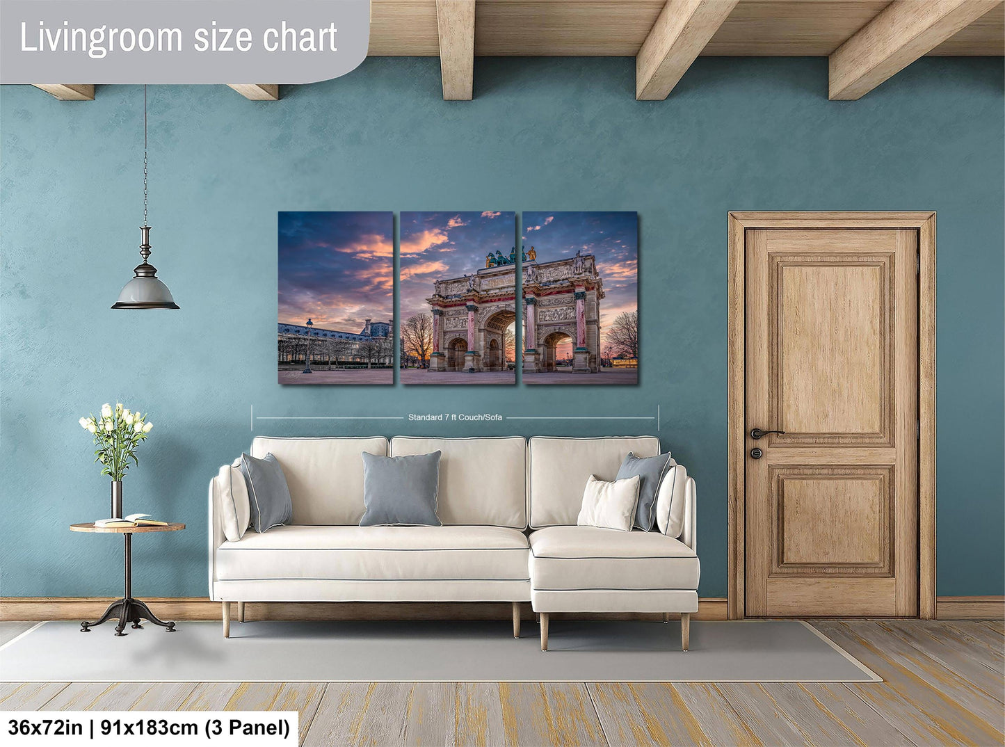 The image is a living room with a large wall art depicting a building, likely a historical or architectural landmark. The room is furnished with a white sofa and a wooden door, and there is a potted plant and a vase on a side table. The wall art is approximately 36 inches wide and measures approximately 91 inches tall, with a 3x3 panel size.