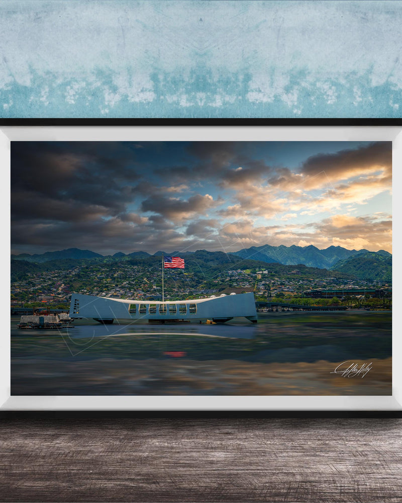 a large white aircraft with a red flag flying on top, situated on a body of water with mountains in the background.