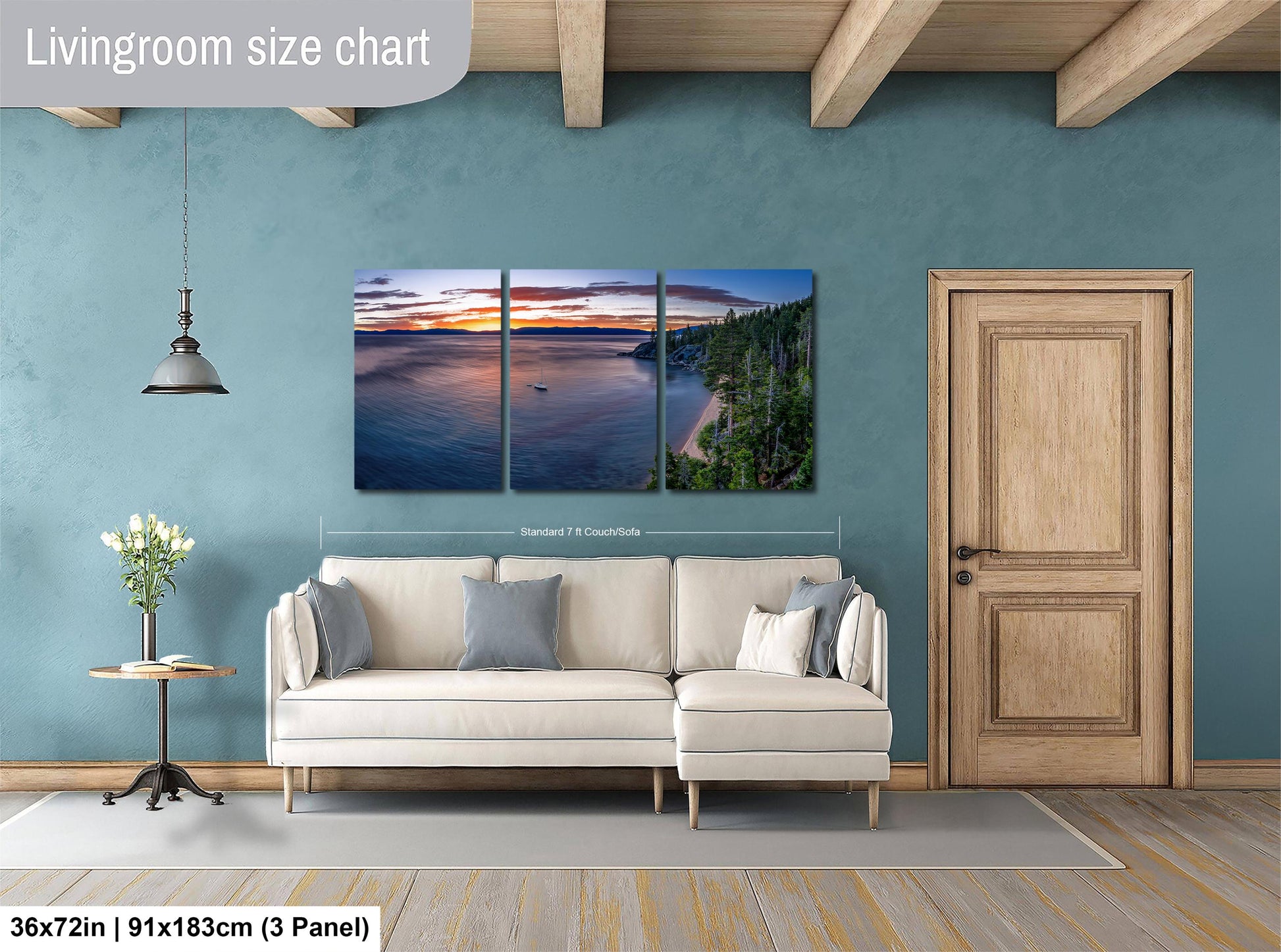 The image is a living room with a large, three-panel landscape painting hanging on the wall. The painting depicts a serene scene of a sunset over a body of water, with a boat visible in the distance. The room is furnished with a white sofa and a wooden door, creating a cozy and inviting atmosphere.