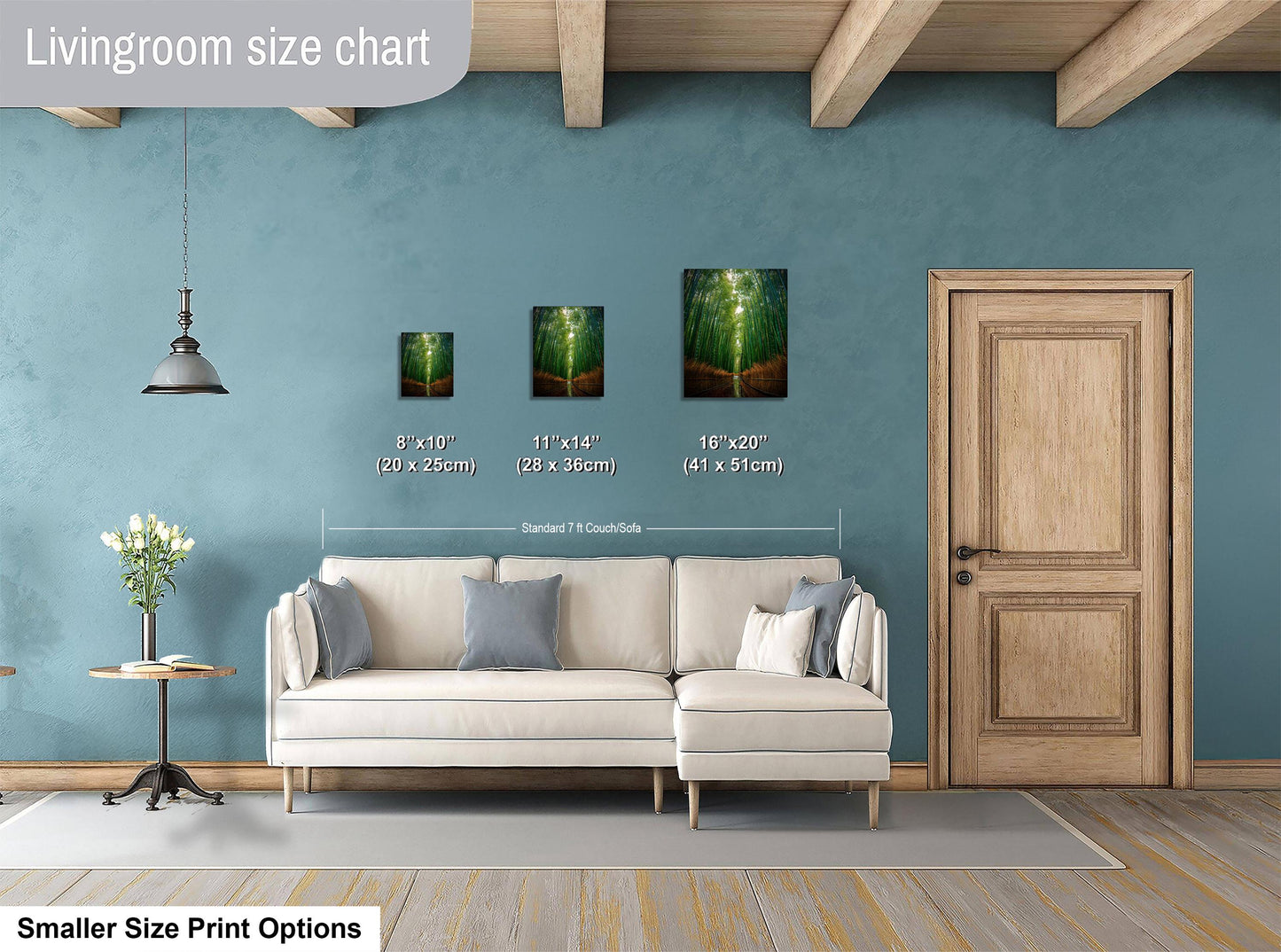 a living room with a white sofa, a wooden door, and a hanging light fixture. There are three framed artworks displayed on the wall, each with a different size and frame. The living room appears to be well-decorated and spacious.