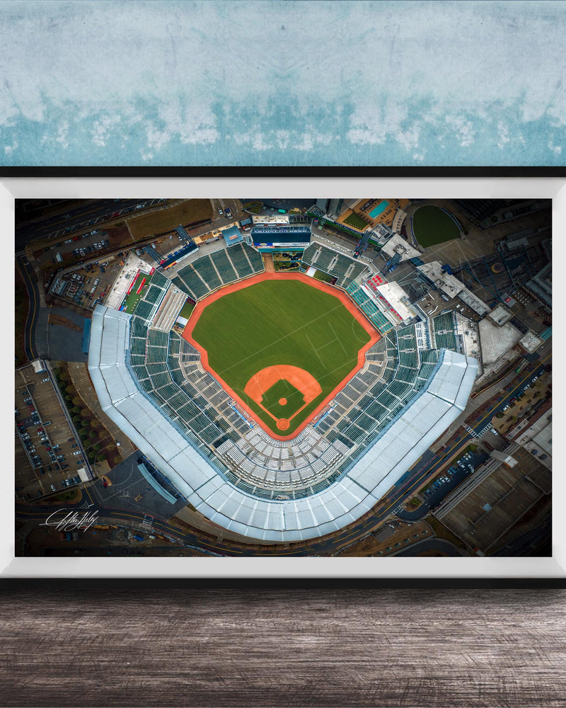 An aerial view of a baseball stadium, with the field, seating areas, and surrounding infrastructure clearly visible.