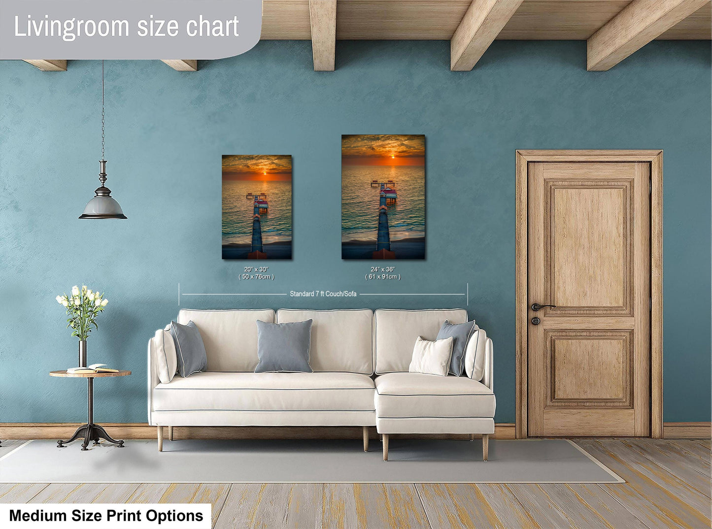 a living room with a white sofa, a wooden door, and a painting of a person standing on a beach. The painting is hung on the wall above the sofa, and the sofa is positioned in front of the painting.