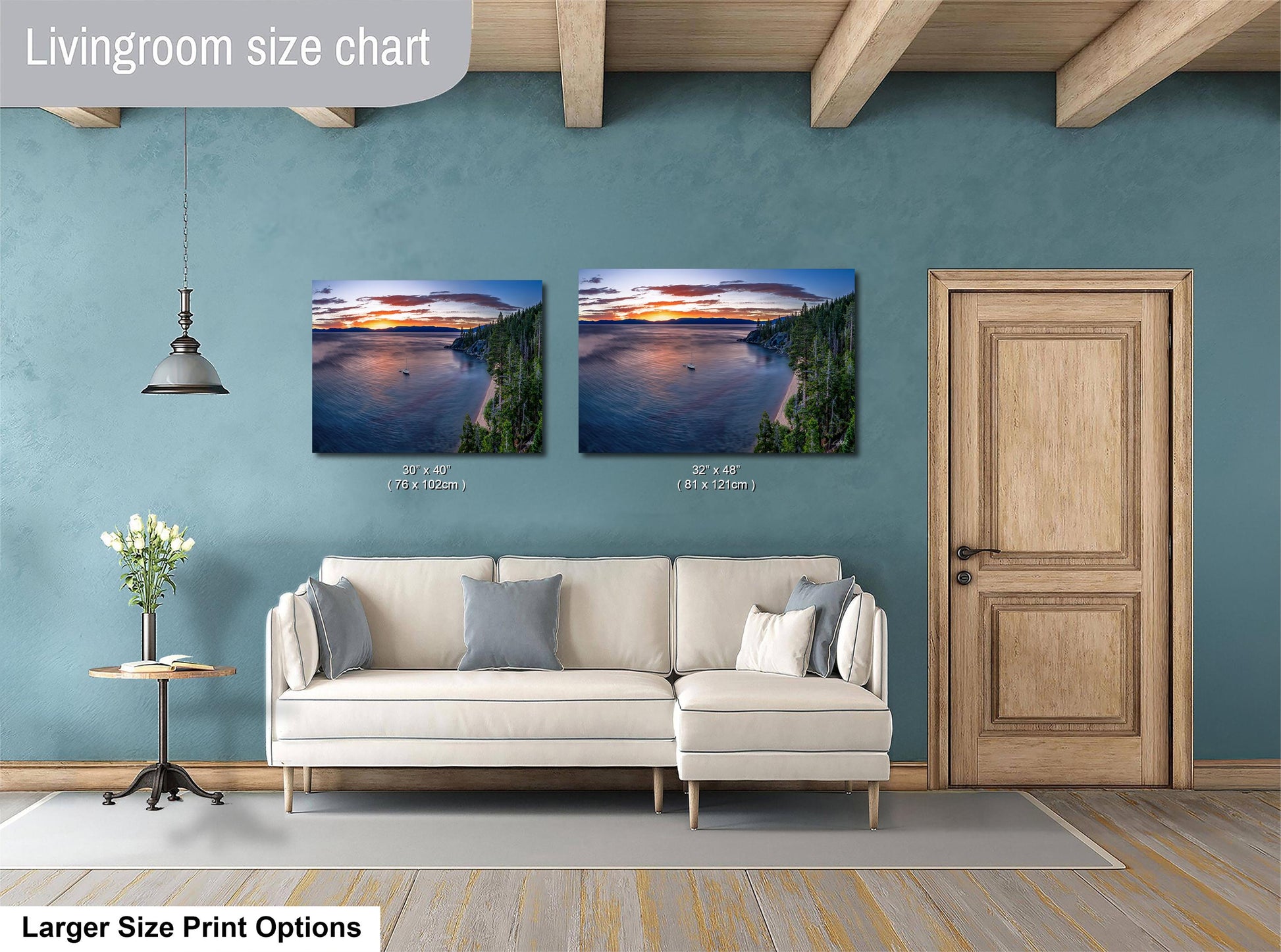 a living room with a white sofa and a wooden door. Above the sofa, there are two framed pictures of a sunset over a lake, with one picture being larger than the other.