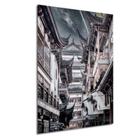 a narrow, winding street in an old city, with traditional Chinese architecture lining both sides. The buildings have ornate roofs and balconies, creating a visually striking scene.