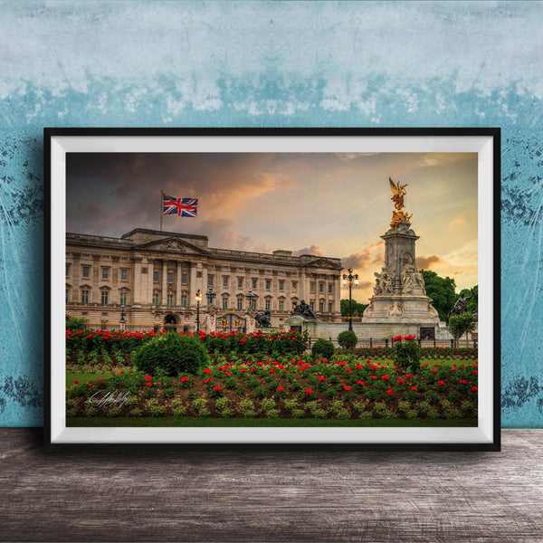 A framed photograph of the Palace of Westminster in London, England, with the British flag flying above the building and a statue in the foreground.