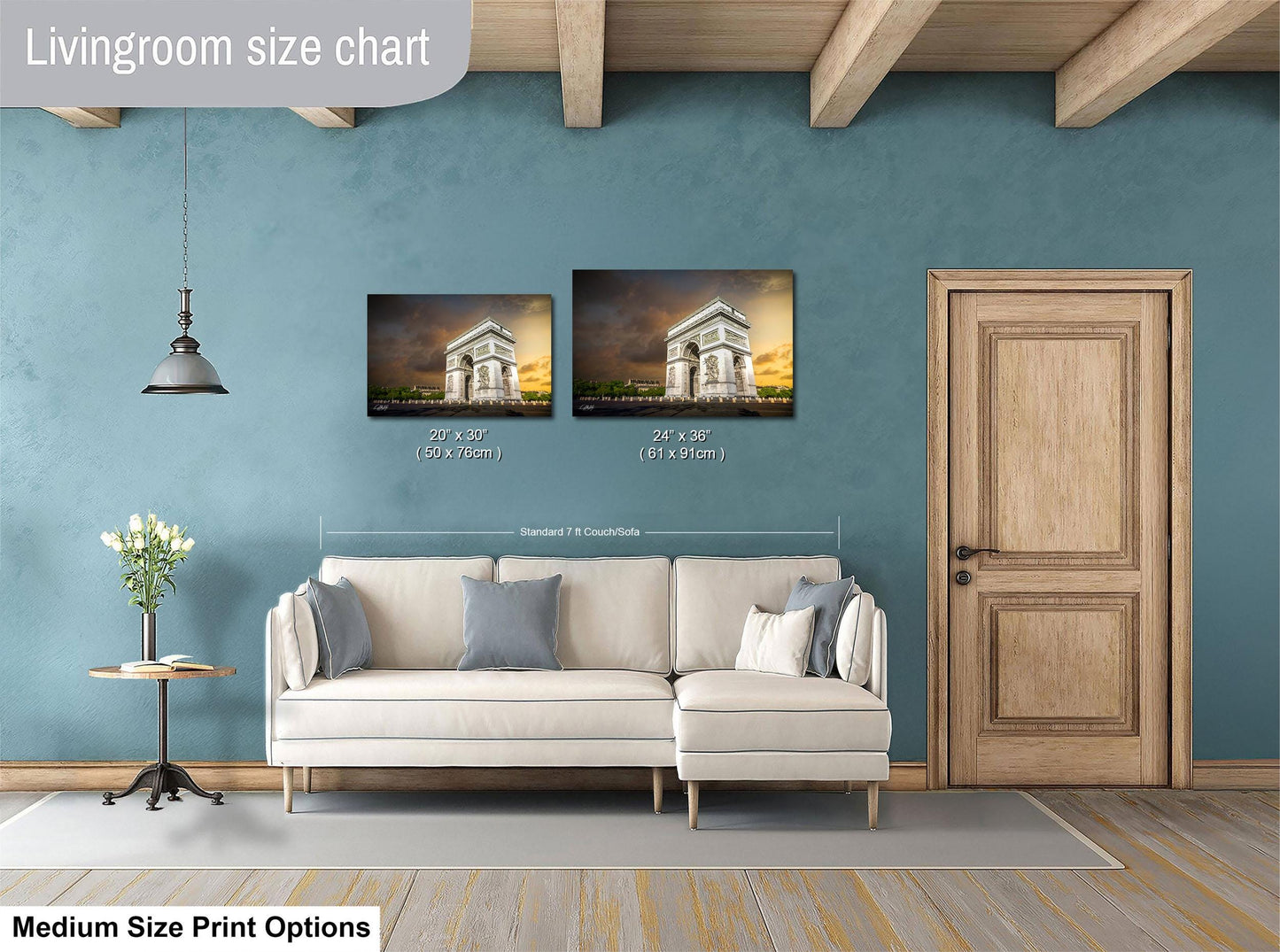 a living room with a white sofa, a wooden door, and a painting of the Arc de Triomphe on the wall.