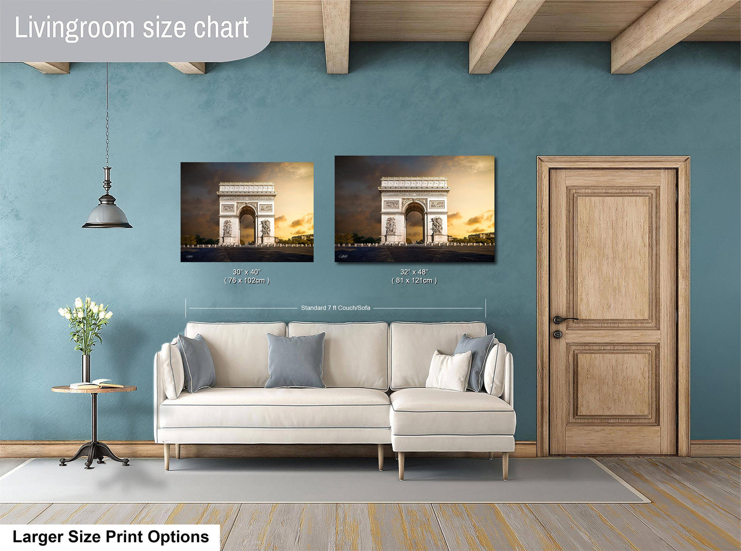 a living room with a white sofa, a wooden door, and a painting of the Arc de Triomphe hanging on the wall.