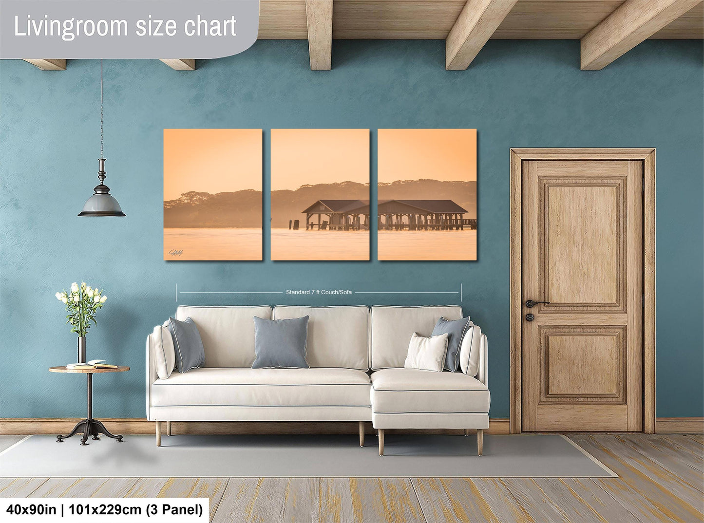 The image is a living room with a large wall-mounted living room size chart displaying the dimensions of the room in inches. The room features a white sofa, a wooden door, and a vase of flowers on a table.