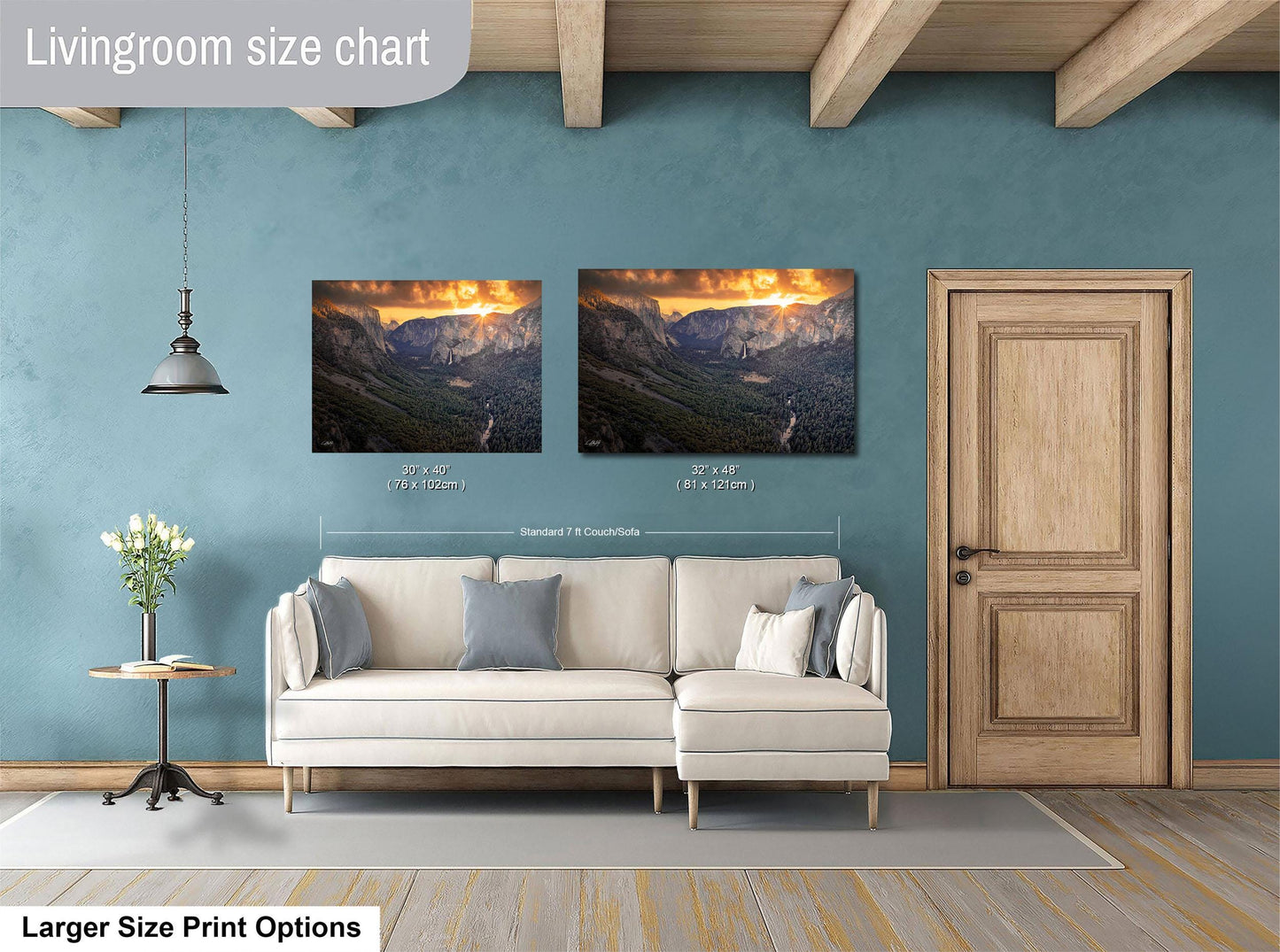 a living room with a white sofa, a wooden door, and two framed landscape paintings hanging on the wall.