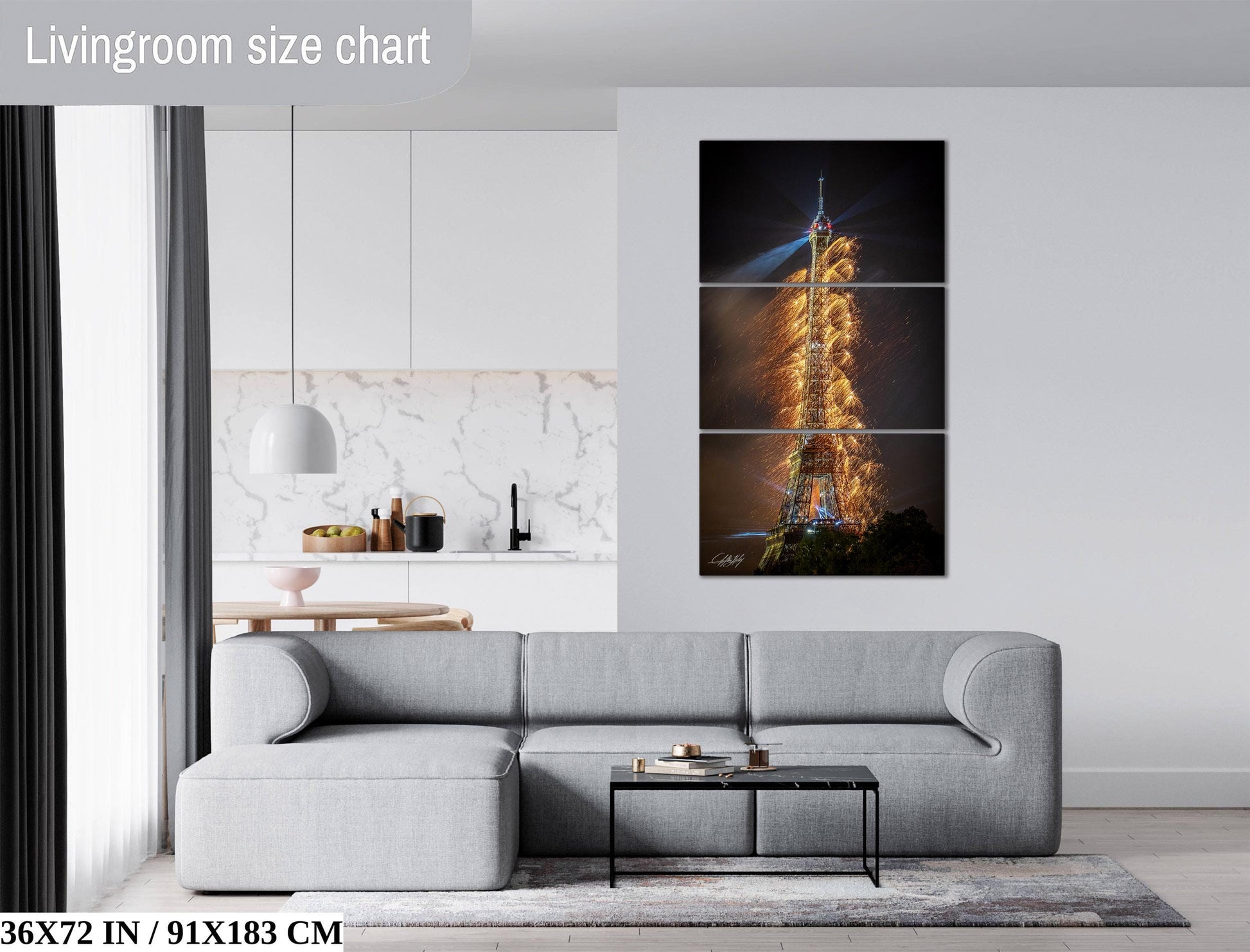 The image is a living room with a gray sofa, a coffee table, and a large wall art depicting the Eiffel Tower with a fireworks display.