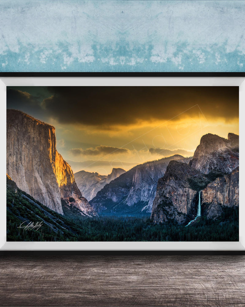 The image is a framed photograph of a breathtaking mountainous landscape at sunset, with dramatic clouds and a waterfall in the foreground.