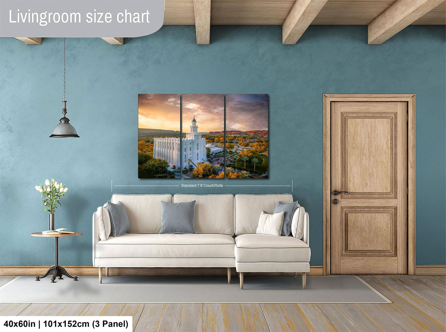 The image is a living room with a large white sofa, a wooden door, and a painting of a temple in the background.