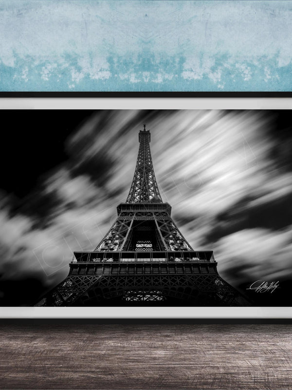 A framed black and white photograph of the Eiffel Tower, a famous landmark in Paris, France.