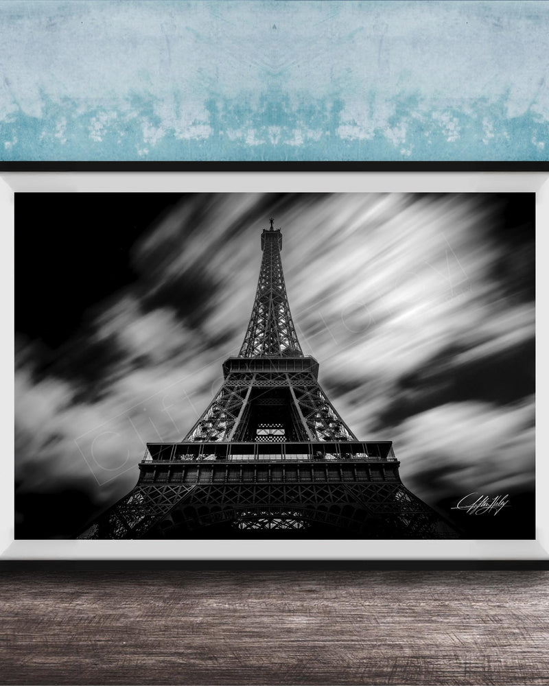 A framed black and white photograph of the Eiffel Tower, a famous landmark in Paris, France.