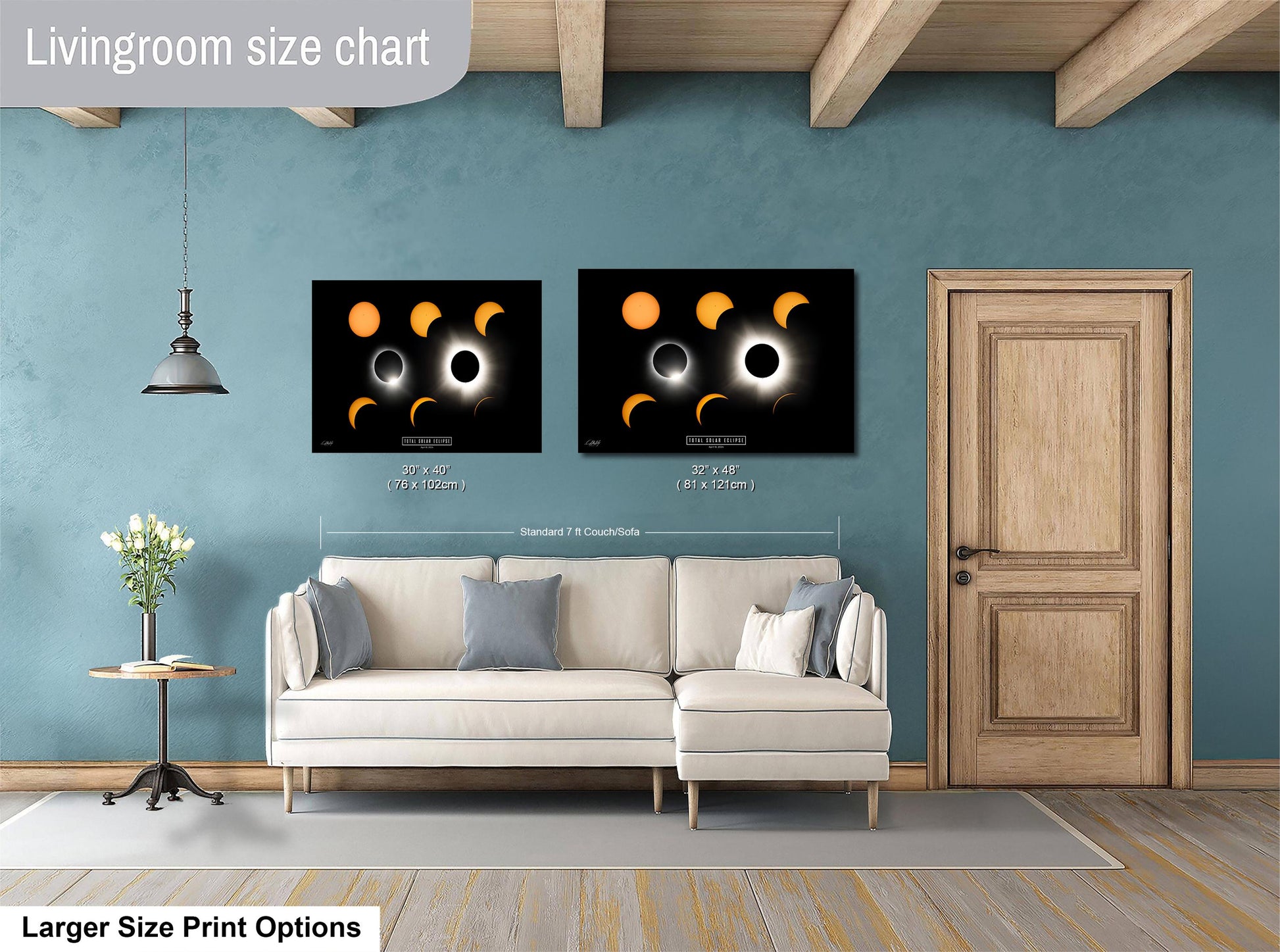 a living room with a white sofa, a wooden door, and two framed prints of the solar eclipse on the wall.