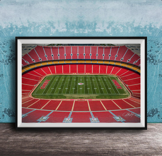 The image is a framed photograph of a football stadium, specifically the Kansas City Chiefs stadium, with a focus on the field and seating areas.