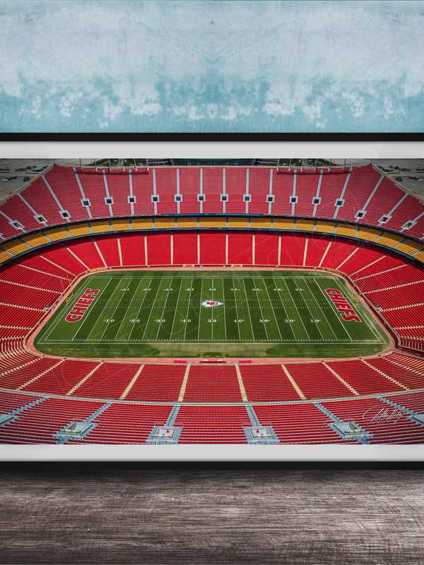The image is a framed photograph of a football stadium, specifically the Kansas City Chiefs stadium, with a focus on the field and seating areas.
