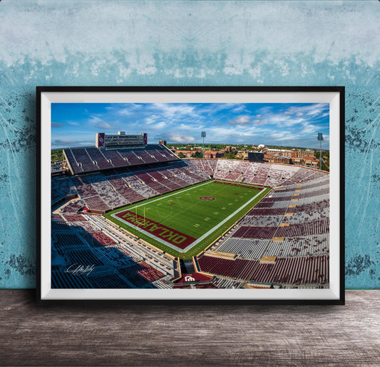 The image is a framed photograph of a football stadium, likely taken from an aerial perspective.