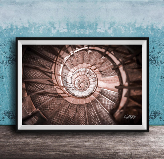 The image is a framed photograph of a spiral staircase, with the steps arranged in a spiral pattern and the image captured from a low angle.
