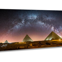 the iconic pyramids of Giza in Egypt, illuminated against a starry night sky.