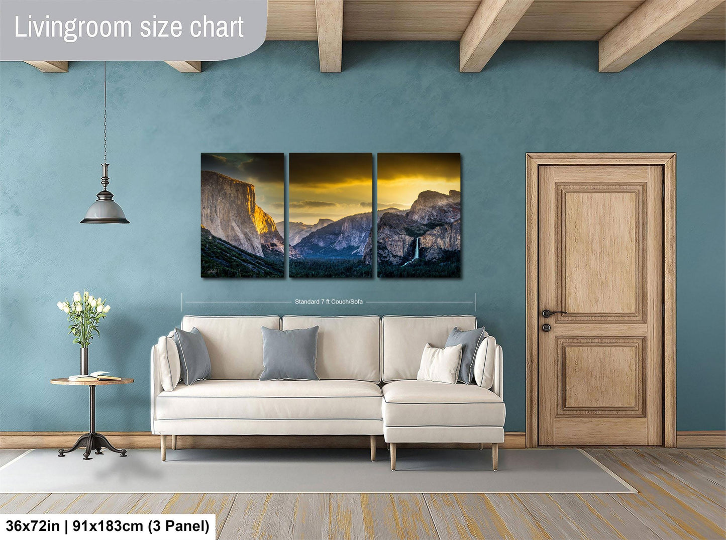 The image is a living room with a large wall art depicting a scenic mountain landscape. The wall art is divided into three panels, with the largest panel covering the entire wall. The room features a white sofa, a wooden door, and a small table with a vase of flowers. The living room size chart indicates that the space is approximately 36 square meters.