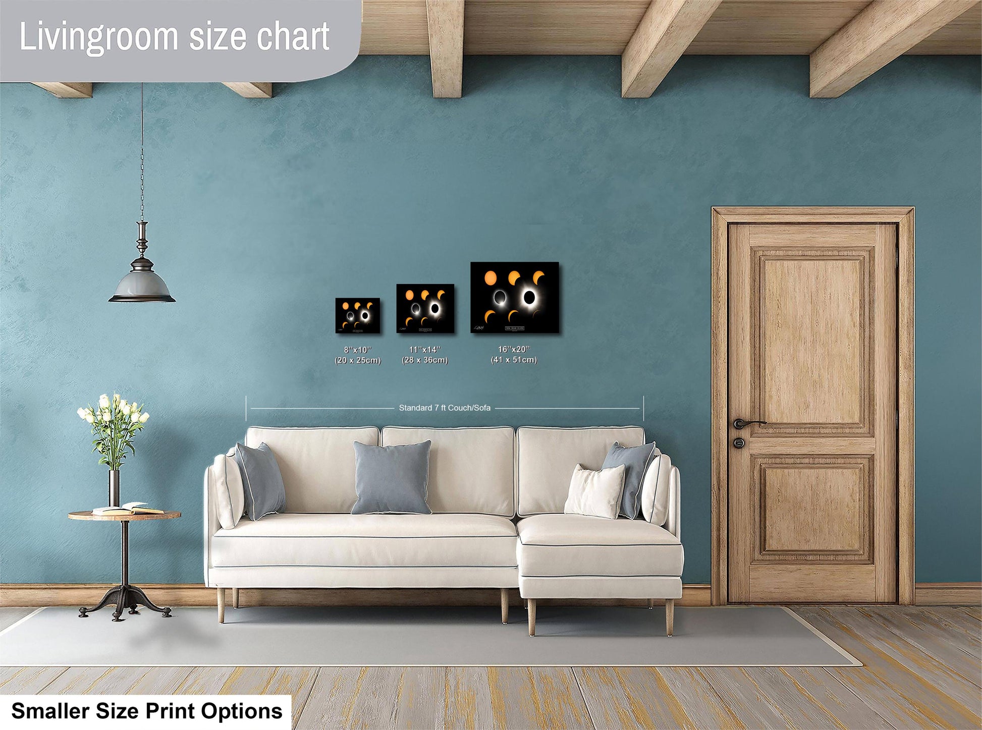 a living room with a white sofa, a wooden door, and a hanging light fixture. There are three framed artworks displayed on the wall, each with different sizes and dimensions. The living room appears to be well-decorated and spacious.