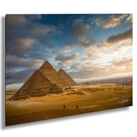 the iconic pyramids of Giza in Egypt, with a dramatic sky and clouds in the background.