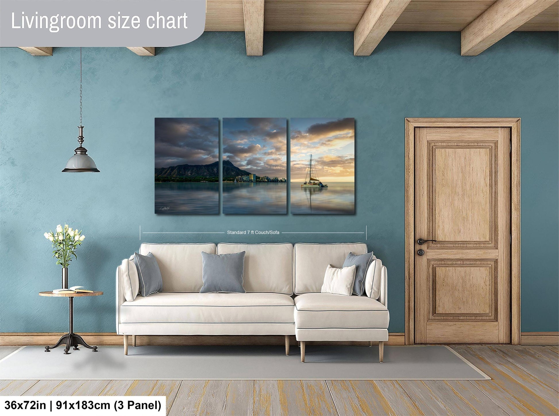 The image is a living room with a large white sofa, a wooden door, and a painting of a seascape on the wall.