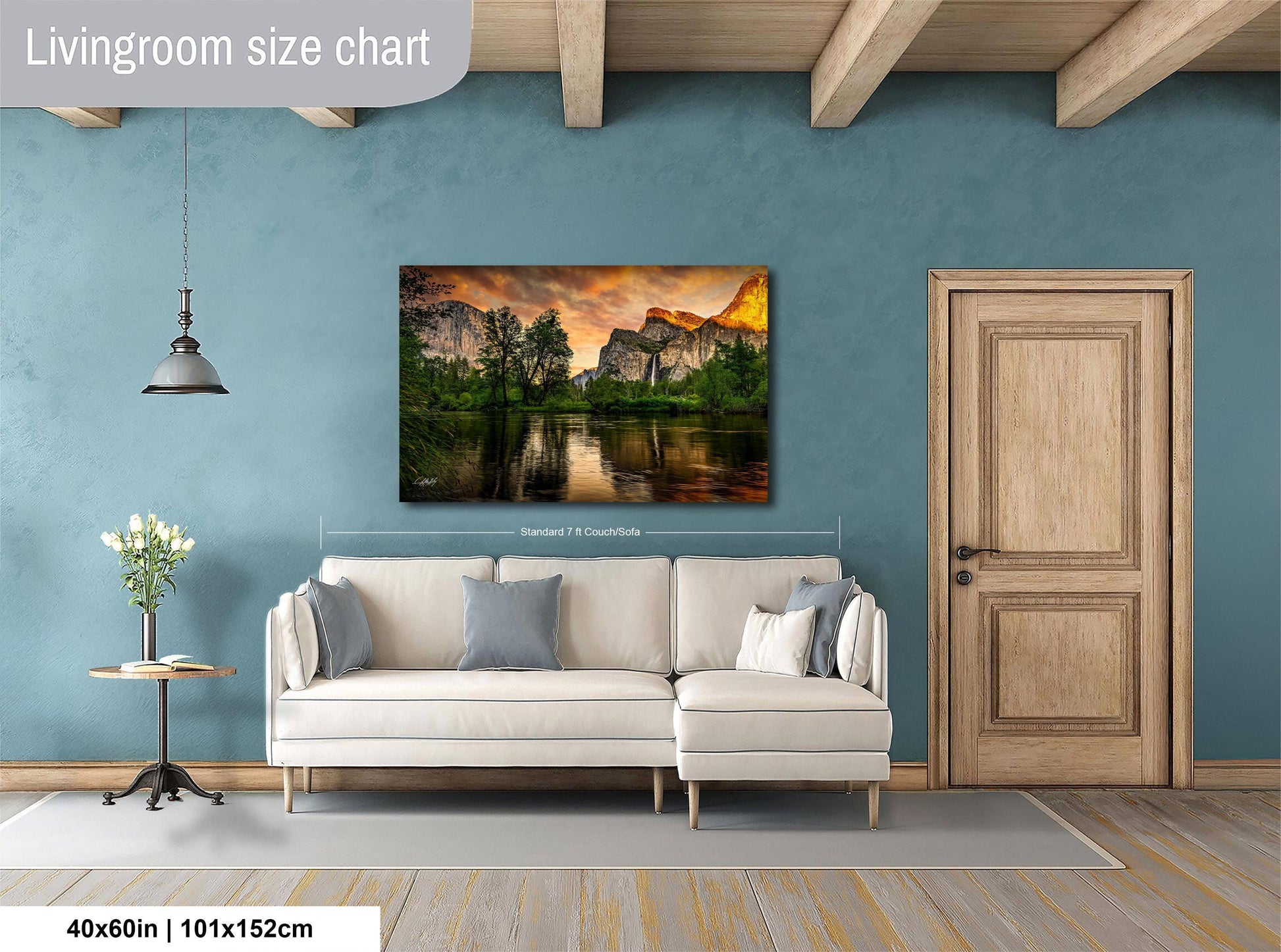 a living room with a large landscape painting hanging on the wall, depicting a serene mountain scene with a lake and trees. The painting is approximately 40 inches wide and 115 centimeters tall.
