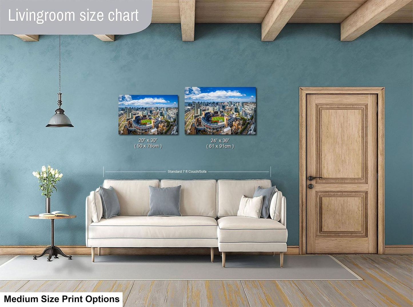 a living room with a white sofa, a wooden door, and a hanging light fixture. Above the sofa, there is a size chart for a medium-sized print, indicating the dimensions of the two framed prints displayed on the wall.