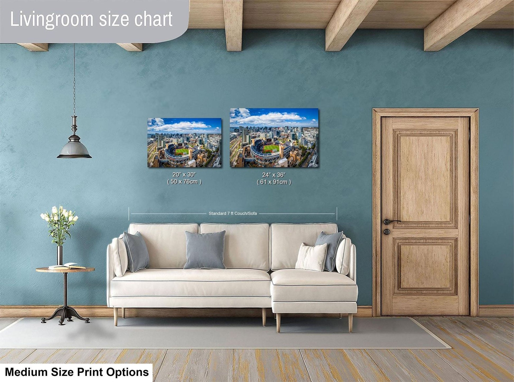 a living room with a white sofa, a wooden door, and a hanging light fixture. Above the sofa, there is a size chart for a medium-sized print, indicating the dimensions of the two framed prints displayed on the wall.