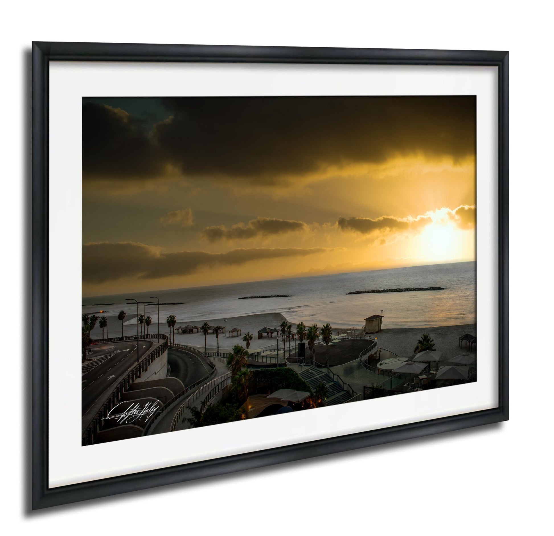 a scenic view of a beach at sunset, with palm trees lining the shore and a body of water in the distance.