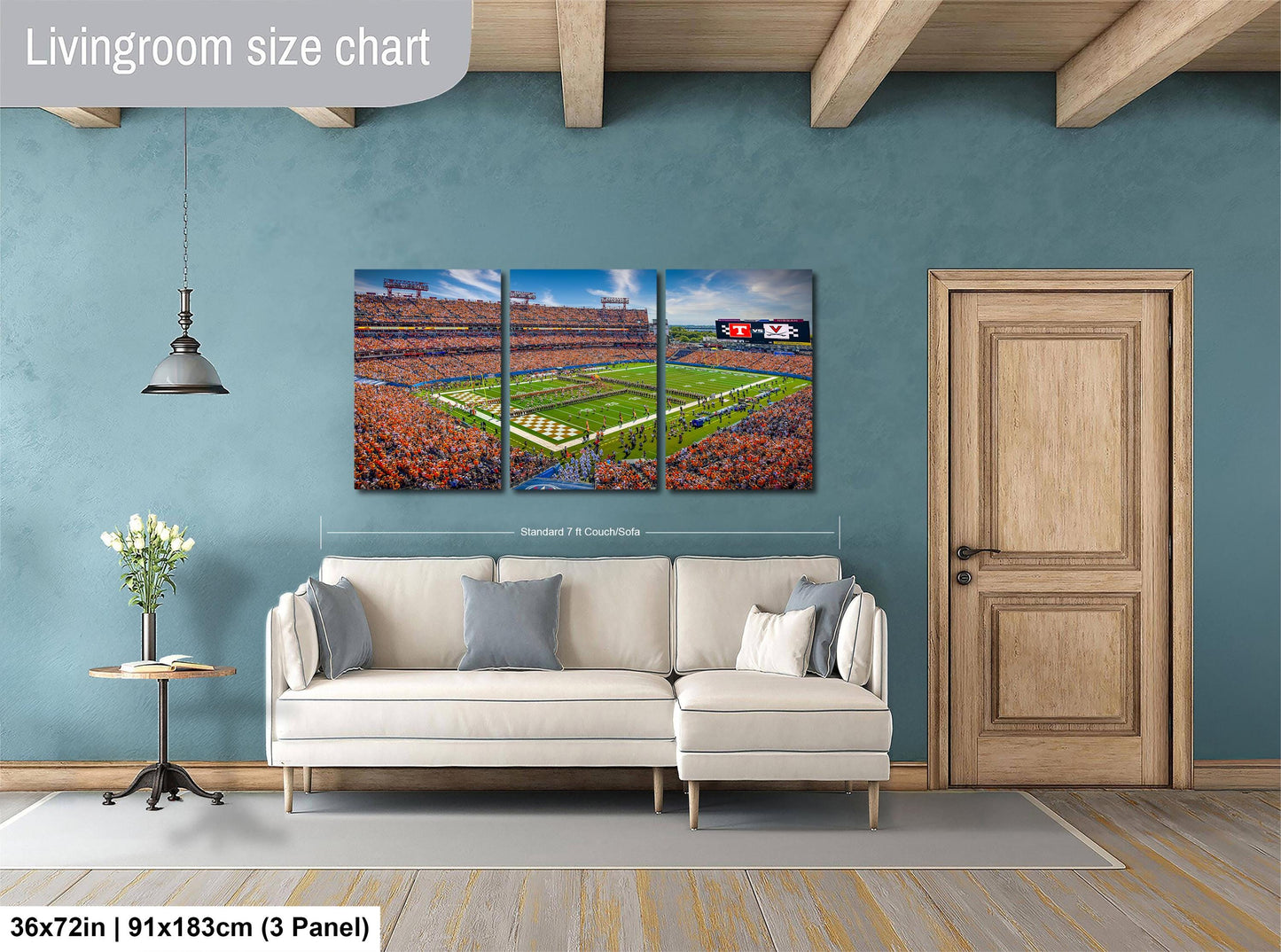 The image is a living room with a large wall art depicting a football stadium. The wall art is a collage of three panels, each showing different aspects of the stadium, such as the field, the crowd, and the surrounding landscape. The living room has a white sofa and a wooden door, creating a cozy and inviting atmosphere.
