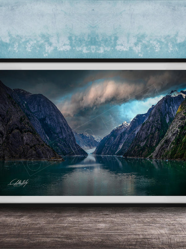a serene landscape with a calm lake surrounded by towering mountains under a dramatic cloudy sky.
