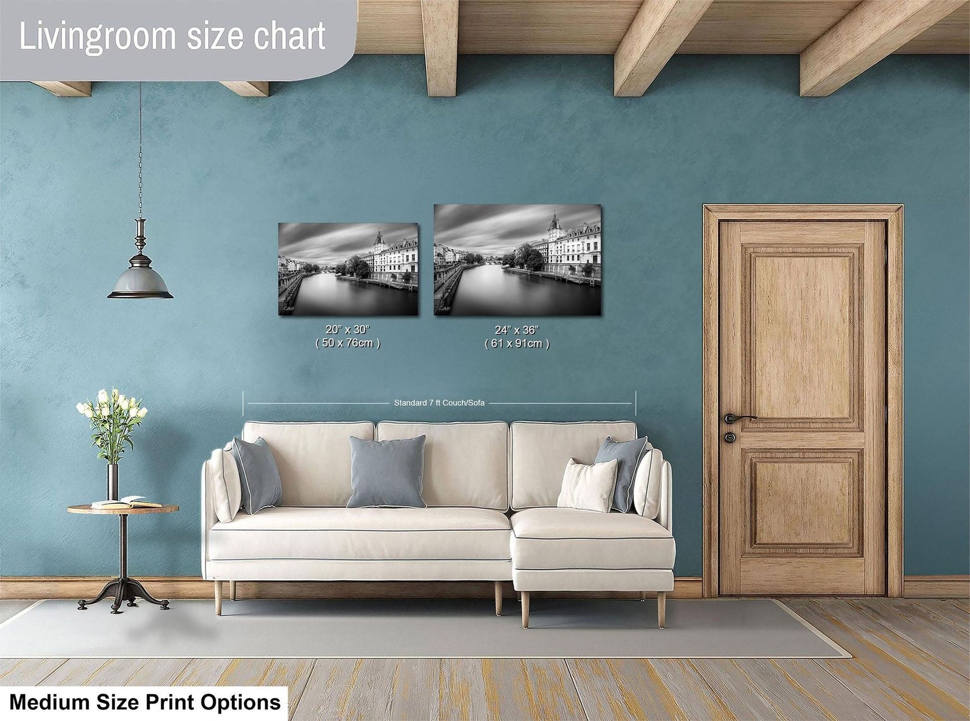 a living room with a white sofa, a wooden door, and a painting of a cityscape on the wall. The living room appears to be designed for relaxation and comfort, with a focus on the artwork and the overall aesthetic.