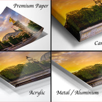 The image is a collage of four photos depicting a sunset over a cityscape, with the top left photo showing a piece of paper, the top right photo showing a canvas wrap, the bottom left photo showing an acrylic print, and the bottom right photo showing a metal or aluminum print.